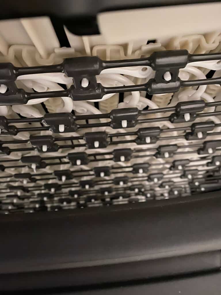 underside of embody chair showing grid support of seat